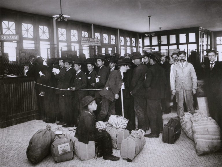 A photo of immigrants waiting to be processed at Ellis Island, reminiscent of many a family history where ancestors made the trip to first come to America