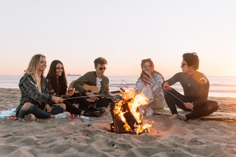 Group of individuals gathered around a campfire, symbolizing the transformative power of sharing personal life stories and collective growth.