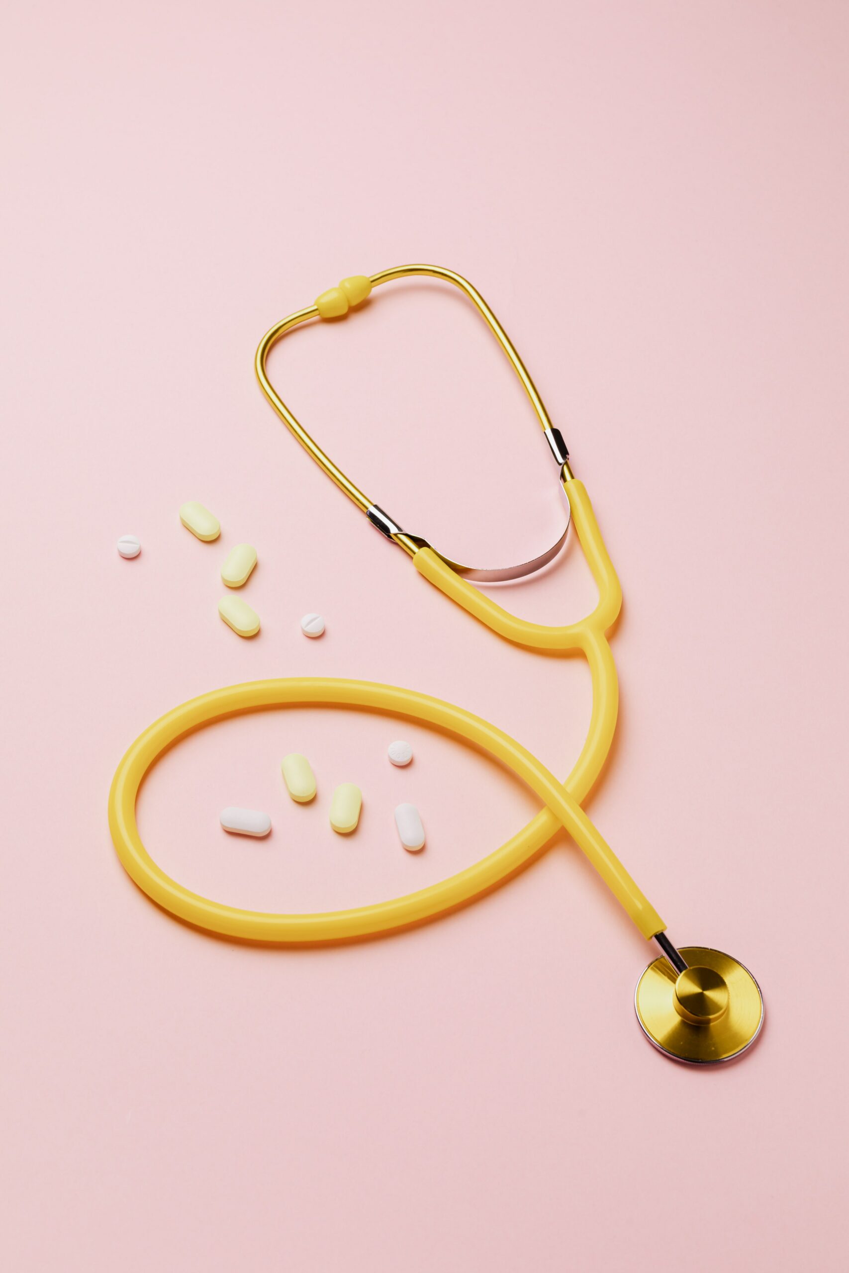 Multivitamin pills accompanied by a stethoscope, symbolizing the potential preventative benefits they offer against the onset of Alzheimer's disease.