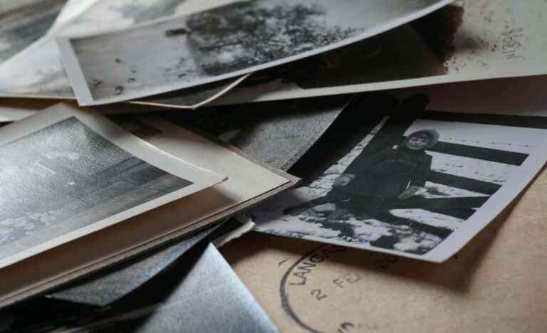 Vintage photos and handwritten letters spread out, symbolizing the significance of preserving family history.