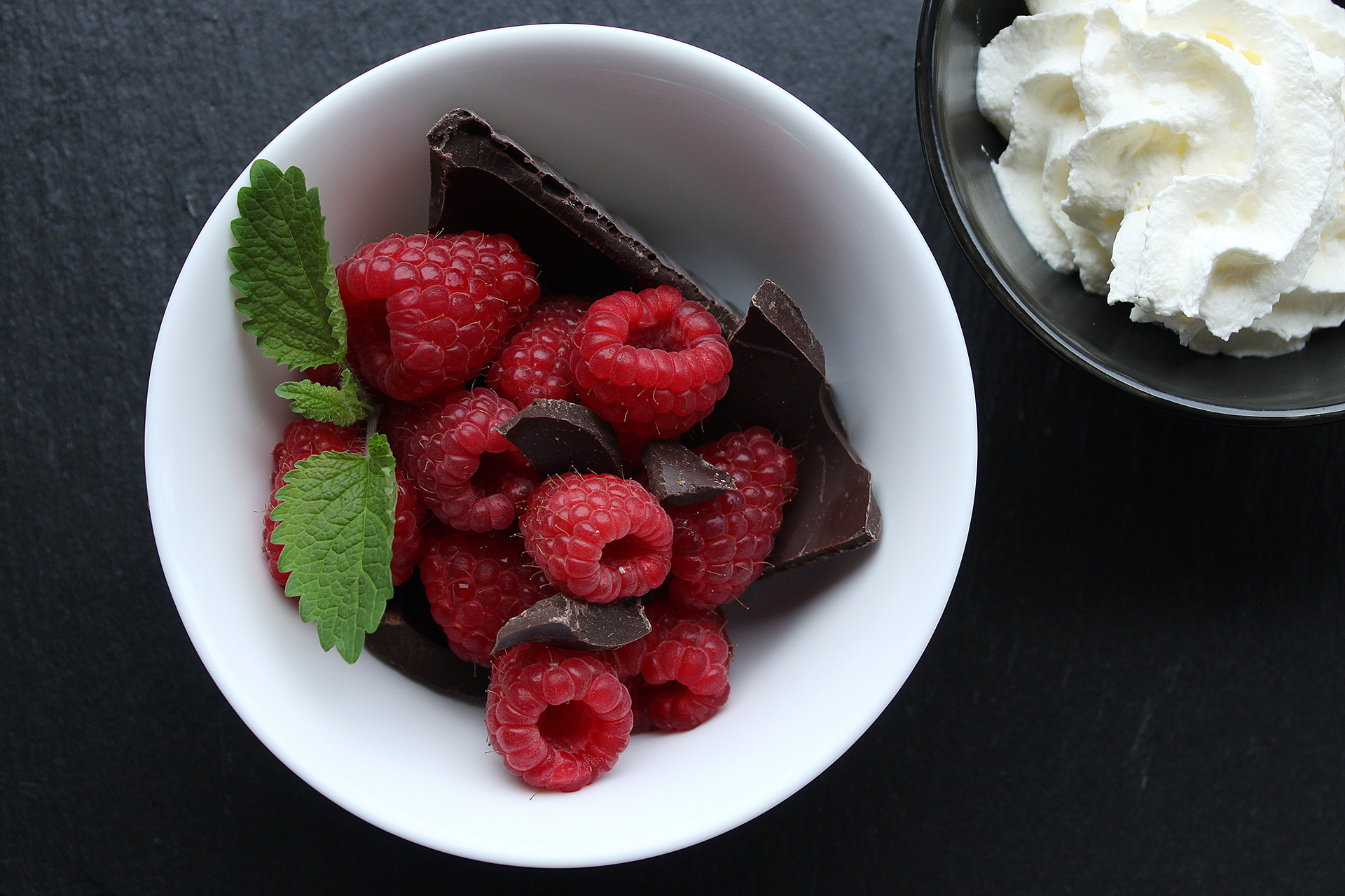 Fresh raspberries with dark chocolate, symbolizing the health benefits of flavanols.